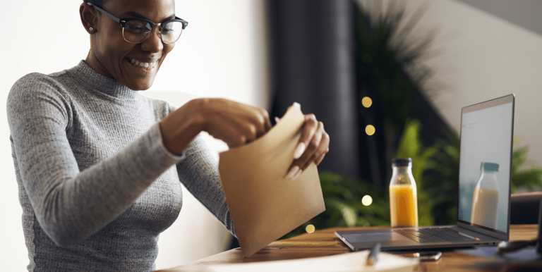 young person opening up an envelope